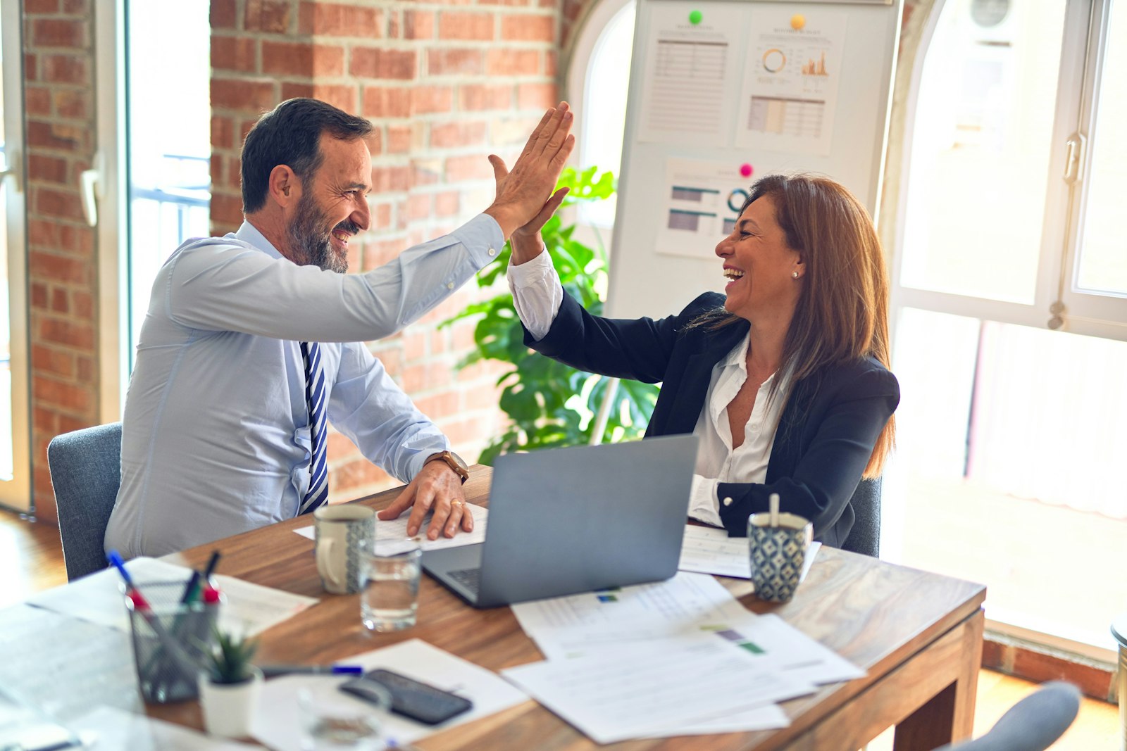 Professionals building referral partner relationships in a business meeting